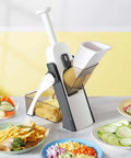 Blue adjustable mandoline slicer and vegetable chopper with 5 blades; front view with feed chute and collection bin.