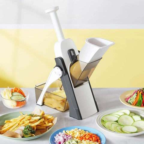 Blue adjustable mandoline slicer and vegetable chopper with 5 blades; front view with feed chute and collection bin.