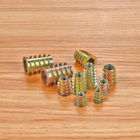 Nine Zinc Alloy Threaded Nut Inserts on Wood Surface - Part of 200 Pcs Zinc Alloy Threaded Nut Inserts Kit For Wood Furniture Nine Sizes M4 M5 M6 M8 M10 With Hex Socket Drive Bolt Fasteners Connectors Rust Resistant Inserts For DIY Projects And Repairs