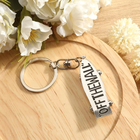 Skateboard Keychain Accessory Realistic Metal Deck Pendant For Men And Women with 'Off The Wall' text on white deck.