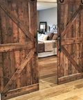 16 Inch Square Sliding Barn Door Handles Set Of 2 Black Matte Iron Gate Pulls installed on wooden barn doors indoors
