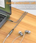 2 Pack Slick 3.5 Mm Aux Extension Cable 6.6 Feet Male To Female Sweet Stereo Sound Adapter connected to a laptop with earphones.