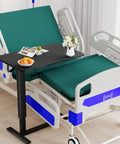 Adjustable Overbed Table With Wheels For Home Use, Extra Large 31.1 Inch By 15.3 Inch Bedside Tray Table in use by hospital bed