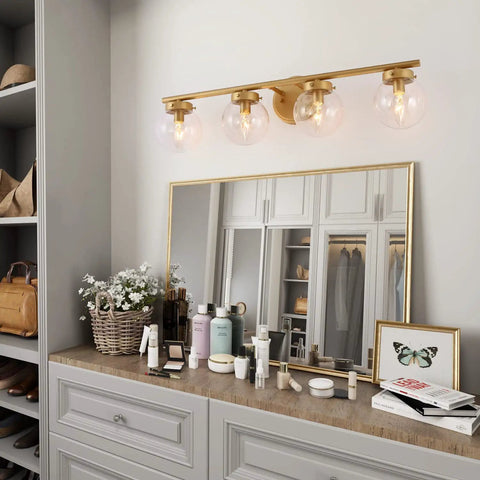 Gold Bathroom Vanity Light 28 Inch Four Light Fixture With Clear Glass Globes, Hand Painted Gold Finish above mirror