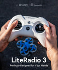 Person holding LiteRadio 3 Remote Control Transmitter with Nano Bay; FPV setup with drone in background.