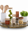 Slick Sixteen Inch Round Wooden Lazy Susan Turntable Organizer with condiments, spices, and kitchen utensils on a countertop.