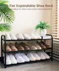 Expandable Three Tier Metal Shoe Rack For Entryway Closet And Doorway Free Standing Heavy Duty Organizer Holds Up To Twelve Pairs Of Shoes Easy To Assemble Space Saving Black with shoes displayed in room corner.