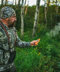 Hunter using Long Range Odorless Wind Detector That Sniffs Out Subtle Breezes And Maps Direction Instantly in the forest.