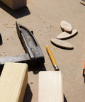 100 Pcs Wood Joiner Biscuits Beech Wood Dowels Set in Three Sizes next to woodworking tools and pencil on a workbench.