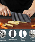 Front view of large stainless steel crinkle cutter with ergonomic rubber handle slicing vegetables on a wooden board