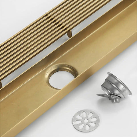 Heavy Duty Rectangular Shower Floor Drain In Sleek Brushed Gold Finish Made From Tough Stainless Steel With Removable Hair Catcher Grate For Quick Dry Performance And Zero Drama In Your Modern Setup, showing drain components.