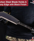 Person holding Pathfinder Scythe Style Machete Heavy Duty Carbon Steel Outdoor Tool with Durable Grip for camping and bushcraft