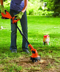 Person using 20V Max Cordless Garden Tiller Kit PowerConnect Tool Only With Dual Tines on lawn for cultivating dry patches.