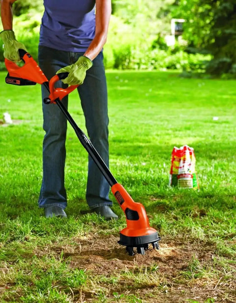Person using 20V Max Cordless Garden Tiller Kit PowerConnect Tool Only With Dual Tines on lawn for cultivating dry patches.
