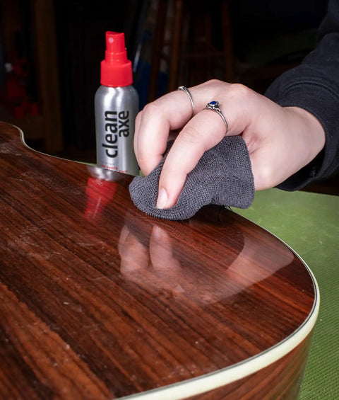 Person using microfiber cloth to polish guitar with Complete Guitar Care Kit And Clean Polish Set With Fretboard Conditioner Three Premium Microfiber Cloths Zero Grease Formula Built For Acoustic Or Electric Axes Pumping Crisp Gloss All Day Long.
