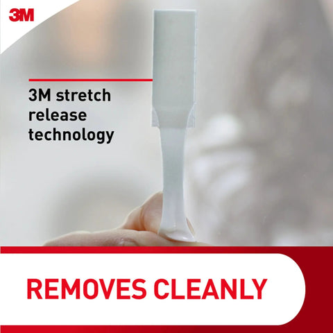 Close-up of hand showing 3M stretch release technology for Damage Free Wire Back Hanger Set With 3 Hangers And 6 Strips No Tools Required Easy Peel And Stick Holds Up To 4 Lbs Per Hanger No Holes Or Sticky Residue On Walls Doors Or Closets.