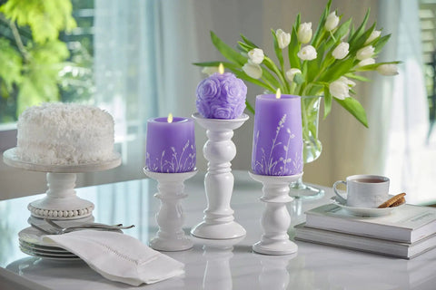 Lavender Glow Flameless Moving Flame Goblet Candle With LED Pillar 4 By 4.5 Inch Embossed Floral Print on white holders.