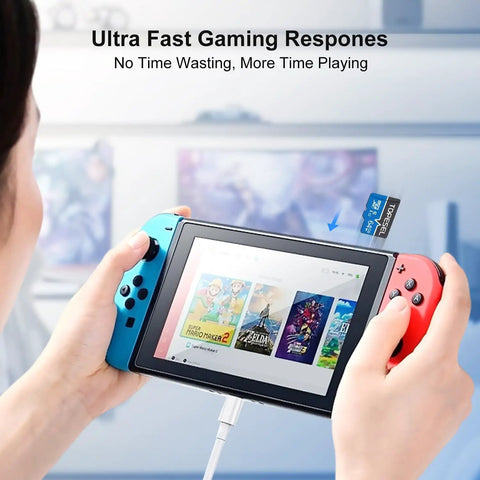 Person inserting 64GB Micro SDXC Memory Card UHS-I Class 10 With 80 MB Per Second Read And 20 MB Per Second Write Speed into gaming console.