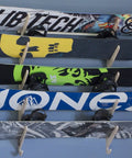 Premium Wall Rack Mount For Ski Snowboard And Longboard Storage Featuring Adjustable Baltic Birch Arms Heavy Duty Gear Holder Holds Up To One Hundred Twenty Pounds with multiple snowboards mounted.