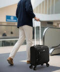 Person with Underseat Carry-On Luggage With Spinner Wheels, Soft Sided 15 Inch Travel Case For Air Travel And Business, Black