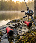 Upgrade Your Gear With This Carbon Fiber Fishing Reel Handle Crank Featuring Double Ergonomic Curved TPE Knobs For Superior Non Slip Grip On Any Baitcasting Setup Perfect For Pond Fishing Adventures. Carbon fiber baitcaster reel handle with red TPE knobs on a lakeside rod