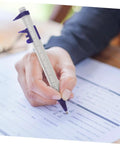 Person writing with caliper pen from Science Party Stationery Gift Set With 12 Sticky Notes 12 Ballpoint Pens And 50 Science Stickers