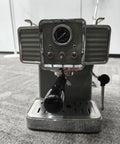 Top Shelf Green Espresso Machine With Integrated Burr Grinder And 15 Bar Pressure Pump for bold creamy shots, front view.