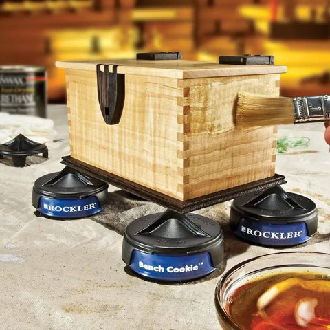 Wooden box elevated on Bench Cookies Finishing Cones 4 Pack For Woodworking Snug Fit Over Work Grippers, Fail Safe Project Finishing System, Cones Nest For Easy Storage, Router Accessories during varnishing process.