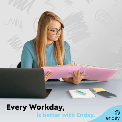 Person holding pink binder, laptop on desk. Label: Two Inch Three Ring Binder With Clear View Cover And Two Inside Pockets