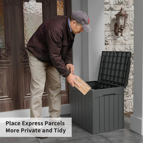 Man places parcel in 31 Gallon Weatherproof Resin Deck Box With Lid For Indoor Outdoor Storage Durable Grey Outdoor Storage Container.