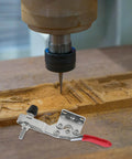 10 Piece Quick Toggle Clamps Set For Vertical Downward Push Heavy Duty Hold Downs For Woodworking And Welding Desktop Clamp Tool Anti Rust Finish Easy Lever Action Rock Solid For Assembly Jigs And Fixtures shown beside a woodworking table.