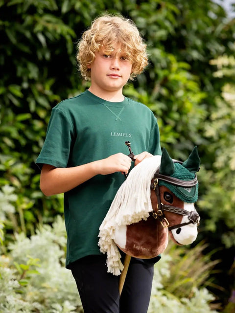Child holding a hobby horse with brown hobby horse bridle with padded leather and lambswool reins and metal bit educational toy for kids 8 plus fits hobby horse tack realistic tacking practice and skill building for little riders