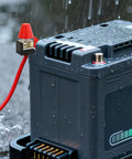 Badass Marine Fuse Block Terminal Holder For EV RV And Yacht Charging Station With 30 To 500 Amp on a battery with water droplets.