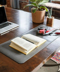 Premium Leather Extended Mouse Pad For Office And Gaming on desk with book and tools