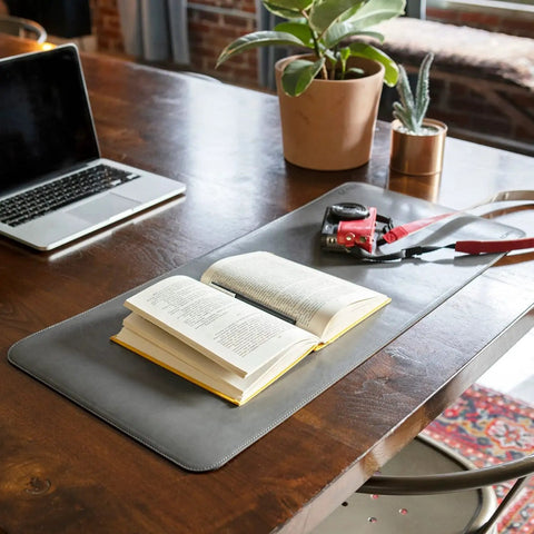 Premium Leather Extended Mouse Pad For Office And Gaming on desk with book and tools