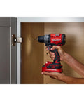 Person using V20 1/2 Inch Cordless Drill Driver Kit with Two Batteries and Charger for fast drilling into cabinet door.