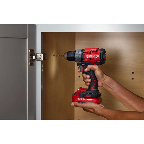 Person using V20 1/2 Inch Cordless Drill Driver Kit with Two Batteries and Charger for fast drilling into cabinet door.