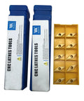 Two blue 1/2-inch indexable lathe turning tool holders with VCMT carbide inserts; yellow insert tray.