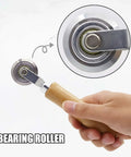 Top Tier 5 Piece Box Resizer Kit Featuring Scoring Wheel Perforator Precision Ruler Craft Knife And Tough Pp Storage Crate For No Sweat Custom Shipping Cartons And Straightforward Diy Builds close-up of scoring wheel bearing roller with wood handle.