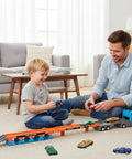 Father and son playing with 2-in-1 Foldable Race Track Truck Playset For Kids Ages 4 To 8 Transforms From Carrier To A 55 Inch Foldable Track