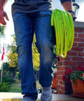 Person carrying Pressure Washer Hose With M22 Fittings, 1/4 In By 25 Ft, ZillaGreen Flexible Hybrid Polymer, Cold Water Only Up To 3100 Psi