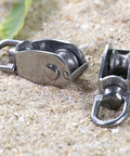 4 Pack M20 Single Pulley Snatch Block Stainless Steel 304 Lift Block With Swivel Hook on sandy surface