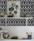 Kitchen scene with Dope Black Damask Peel And Stick Wallpaper For Walls And Furniture Self Adhesive Vinyl Contact Paper Removable Decorative Wall Covering Vintage Look Ideal For Cabinets Desks And Bedrooms, showcasing black and white damask pattern behind a shelf with kitchen items.