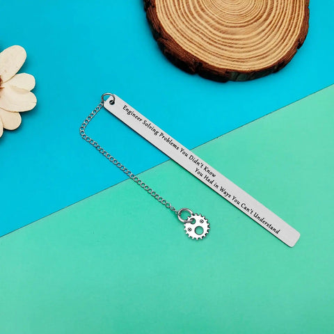 Gearhead Nerdy Twist Bookmark Gift With Velvet Pouch Stainless Steel Bookmark For Mechanical And Design Engineers Techies Students And Book Lovers Graduation Gift For Engineering Nerds displayed with chain and gear charm on a blue background.