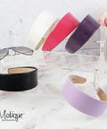 Slay Your Daily Hair Game With This Super Comfy Two Inch White Vegan Leather Headband For Women featuring various colors displayed.