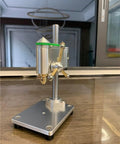 Industrial Grade Mini Bench Drill Press With Precision Variable Speed Control on a wooden table, featuring aluminum alloy body and brass spindle.