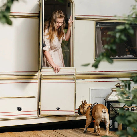 Woman and dog at RV door using 4 Pack Trailer Door Holder Kit Rubber Low Profile Bumper Door Stop For RVs Trailers Campers And Horse Trailers Black Fits Most Cargo And Travel Trailers.