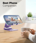 Dual Folding Phone Stand With Fully Adjustable Angles For IPhone 17 16 15 14 13 12 11 Pro Max Xs Xr X 8 And Nintendo Switch Desktop Cradle Dock All Phones Purple on desk with phone