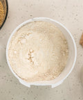 Beefy 1200W High Speed Electric Grain Mill For Fresh Flour Compact Impact Grinder With Stainless Steel Milling Heads Wheat Grinder For Smooth Bread Flour Texture showing freshly milled flour in bin