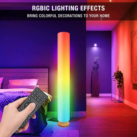 Music Sync RGBIC Floor Lamp with Dimmable LEDs in bedroom setting, rainbow lighting effect, remote control in hand